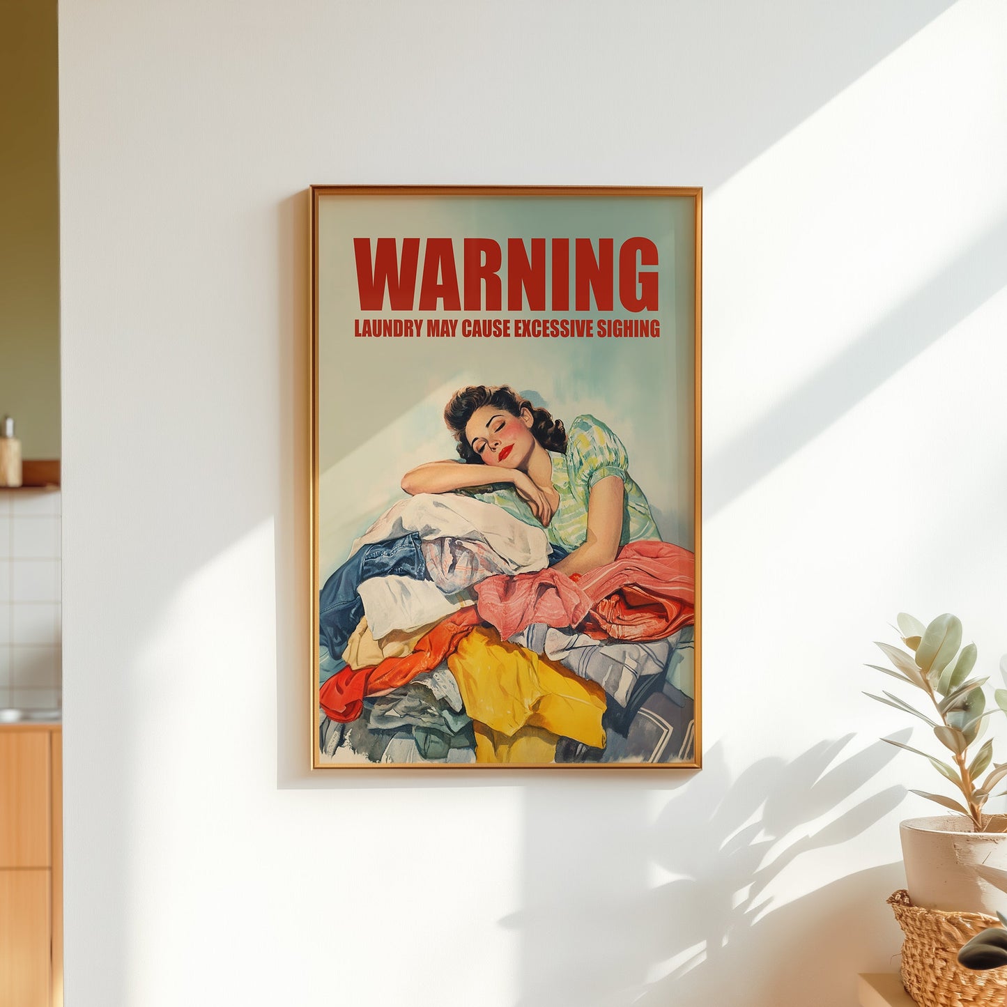 Vintage illustration of a 1950s housewife leaning her head on a large pile of colorful laundry with 'WARNING: LAUNDRY MAY CAUSE EXCESSIVE SIGHING' in bold red text; funny retro laundry room wall art.