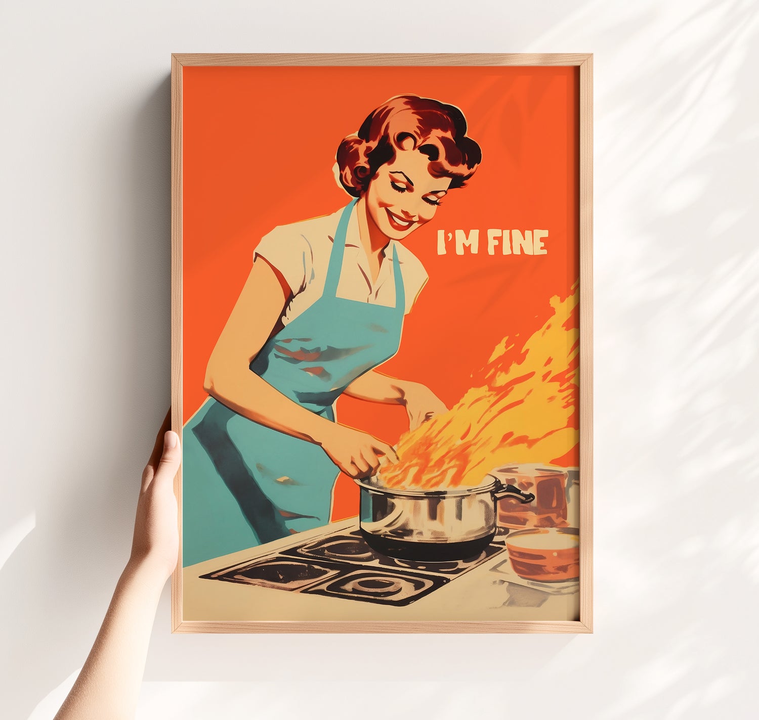 Orange I’m Fine kitchen wall art displayed in a light wooden frame.