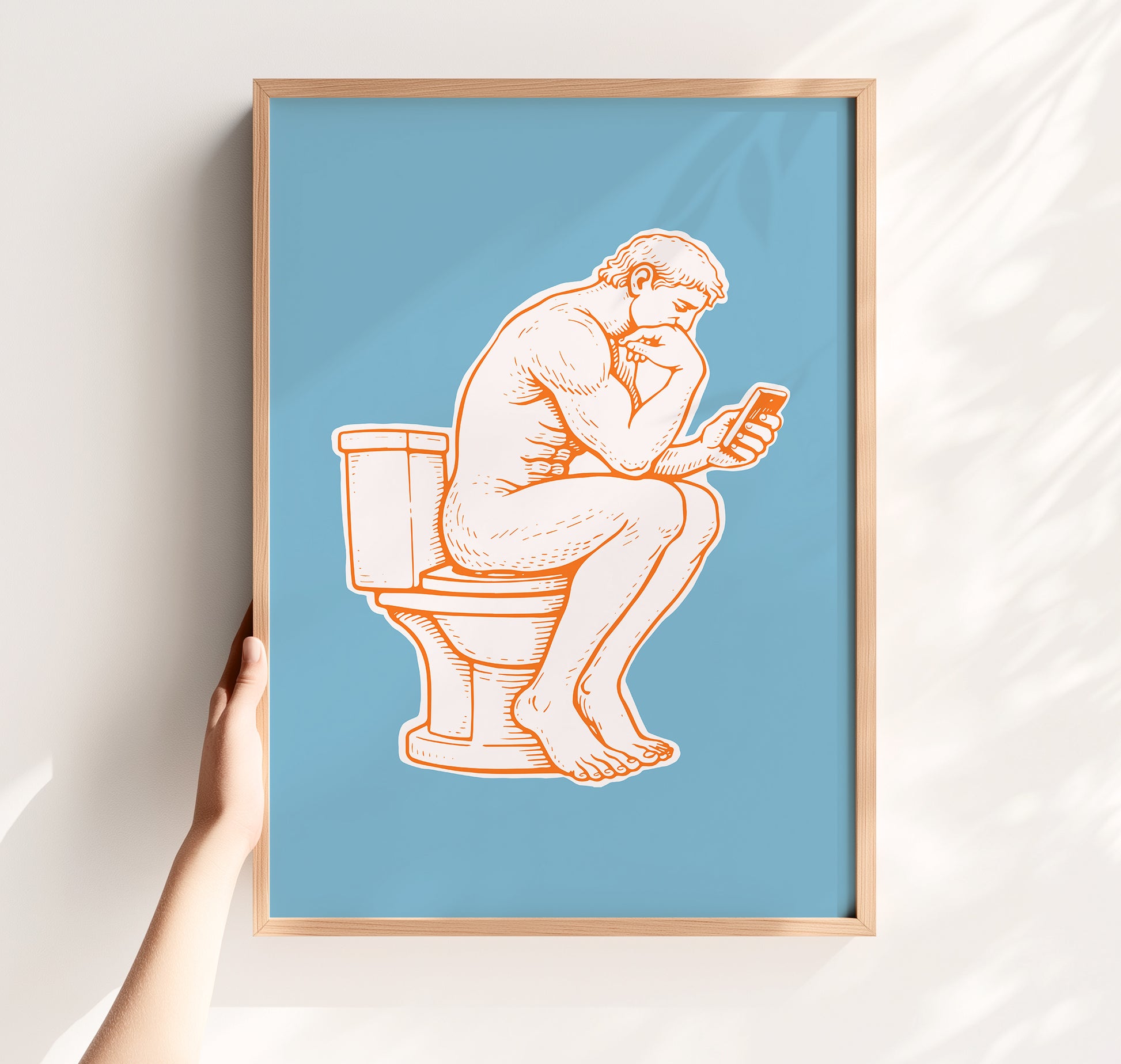 Modern toilet poster of a man on toilet with a phone in hand in a thinker parody pose, minimalist bright blue white and orange funny toilet print  and funny bathroom decor idea.
