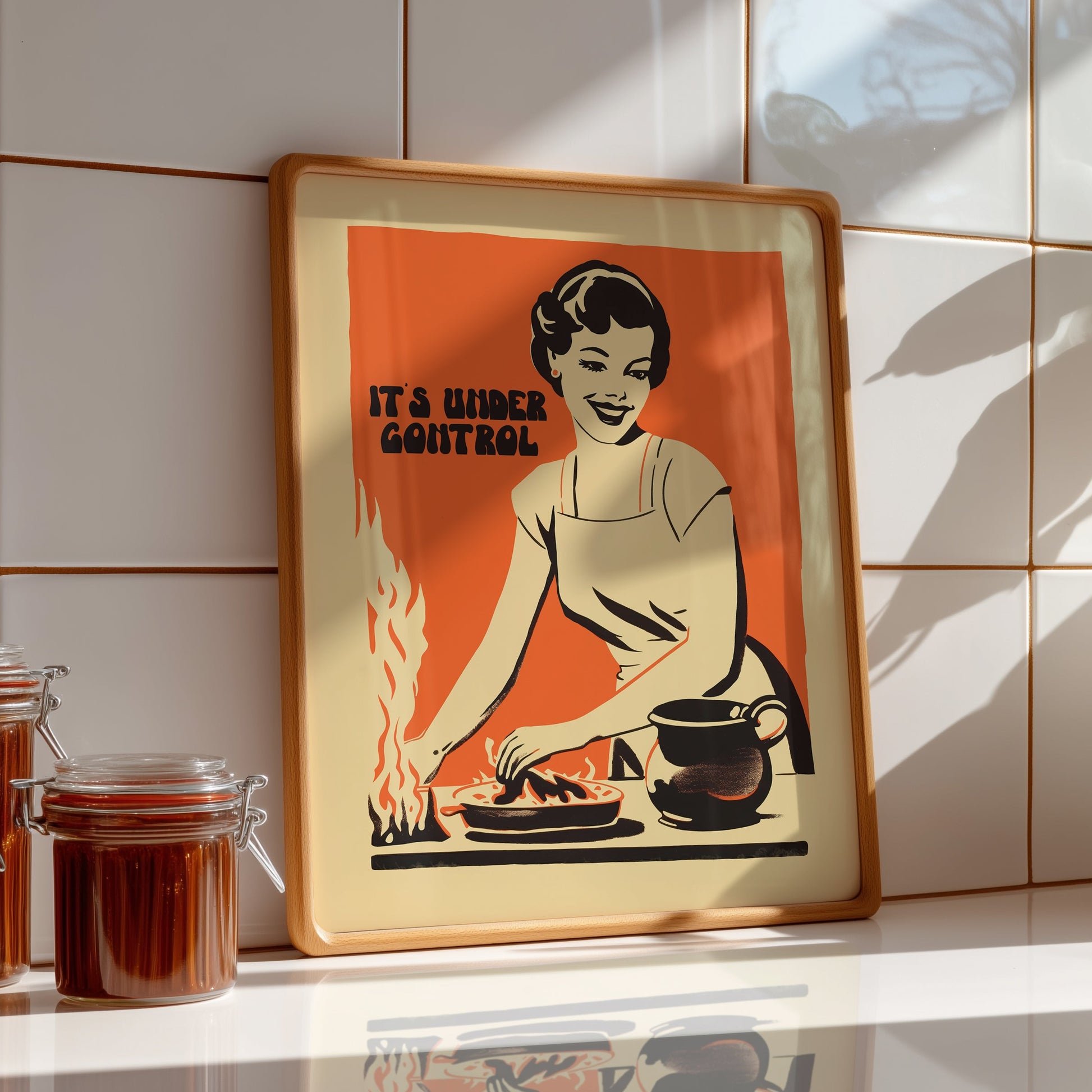 Retro housewife cooking with flames and the text “It’s Under Control,” nostalgic funny kitchen wall art poster for retro cafe or home kitchen decor.