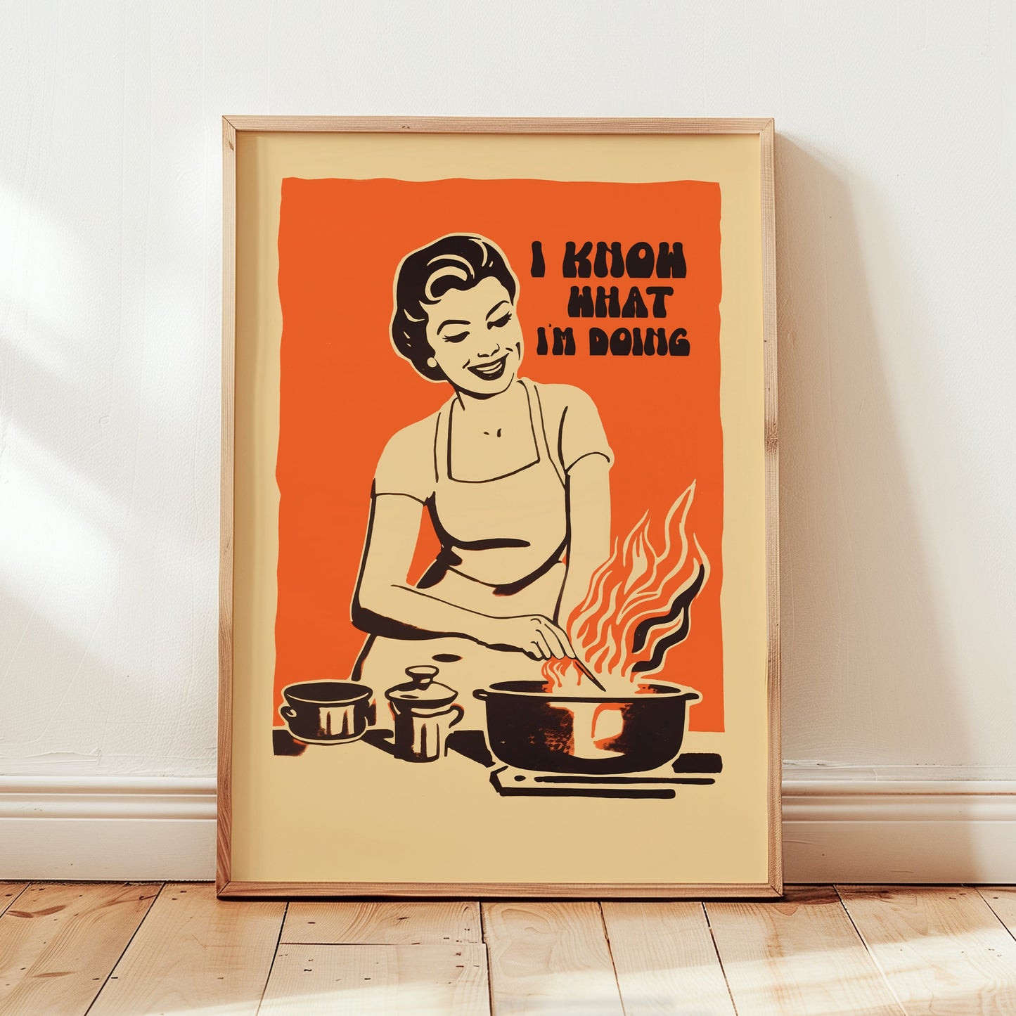 Midcentury housewife cooking over flames with the text “I Know What I’m Doing,” nostalgic retro kitchen wall art print for family kitchen decor.