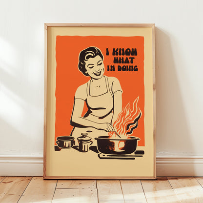 Midcentury housewife cooking over flames with the text “I Know What I’m Doing,” nostalgic retro kitchen wall art print for family kitchen decor.