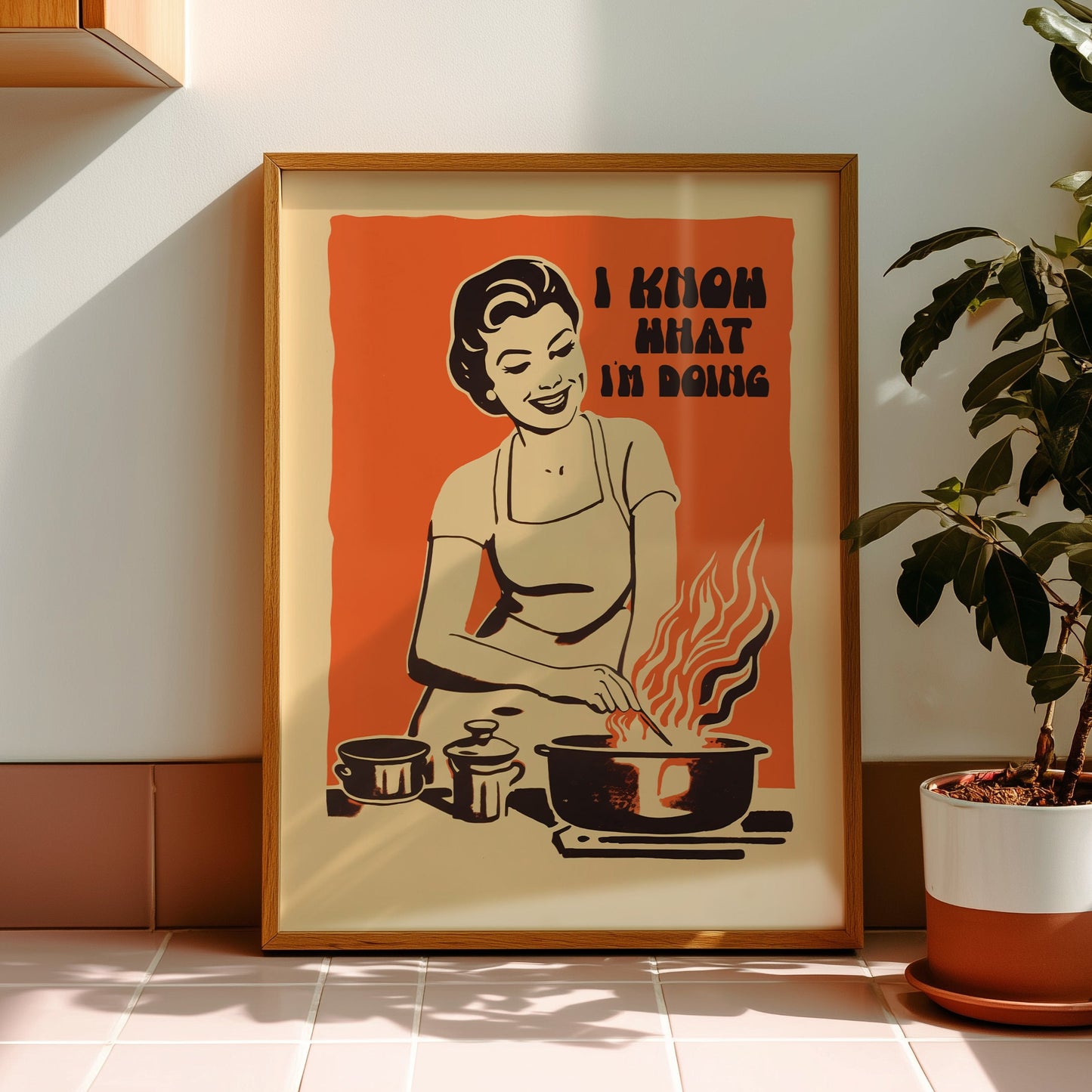 Midcentury housewife cooking over flames with the text “I Know What I’m Doing,” nostalgic retro kitchen wall art print for family kitchen decor.