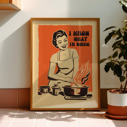 Midcentury housewife cooking over flames with the text “I Know What I’m Doing,” nostalgic retro kitchen wall art print for family kitchen decor.
