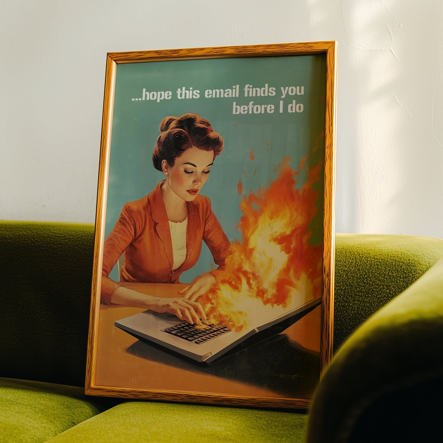 Retro 1950s style woman typing on a flaming laptop with the quote “Hope this email finds you before I do,” funny office wall art for work from home or cubicle decor.