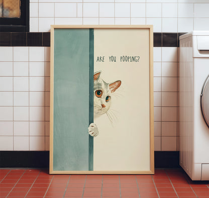Funny cat bathroom poster hanging on a modern neutral wall above a toilet, showing the relatable "Are You Pooping?" quote.