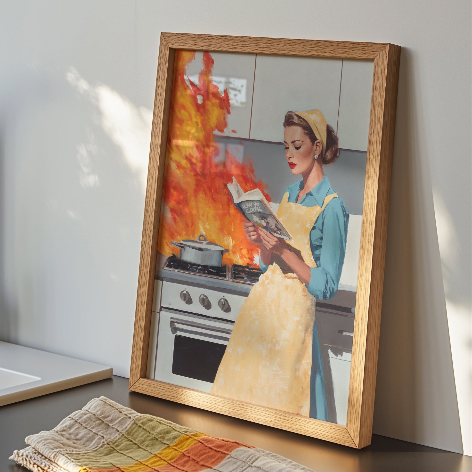 Vintage illustration of a 1950s housewife in a yellow apron calmly reading a cookbook while a fire erupts on a retro stove behind her; funny mid-century modern kitchen wall art.

