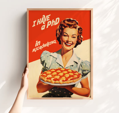Vintage-style illustration of a smiling 1950s housewife in a blue polka dot dress holding a pie, with the text 'I Have a PhD in Microwaving' on a red and white background; humorous retro kitchen wall art.