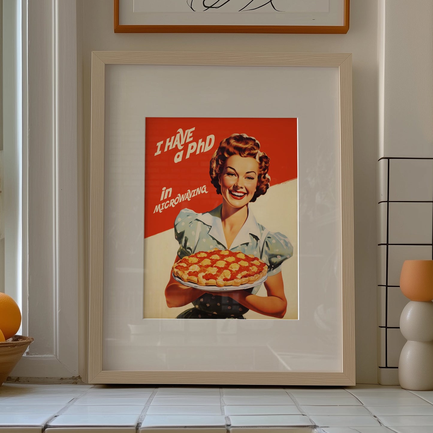 Vintage-style illustration of a smiling 1950s housewife in a blue polka dot dress holding a pie, with the text 'I Have a PhD in Microwaving' on a red and white background; humorous retro kitchen wall art.
