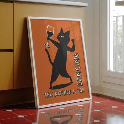 Retro illustration of a sassy black cat dancing while holding a wine glass on a burnt orange background, text reads "This Kitchen is for Dancing" in a vintage font.
