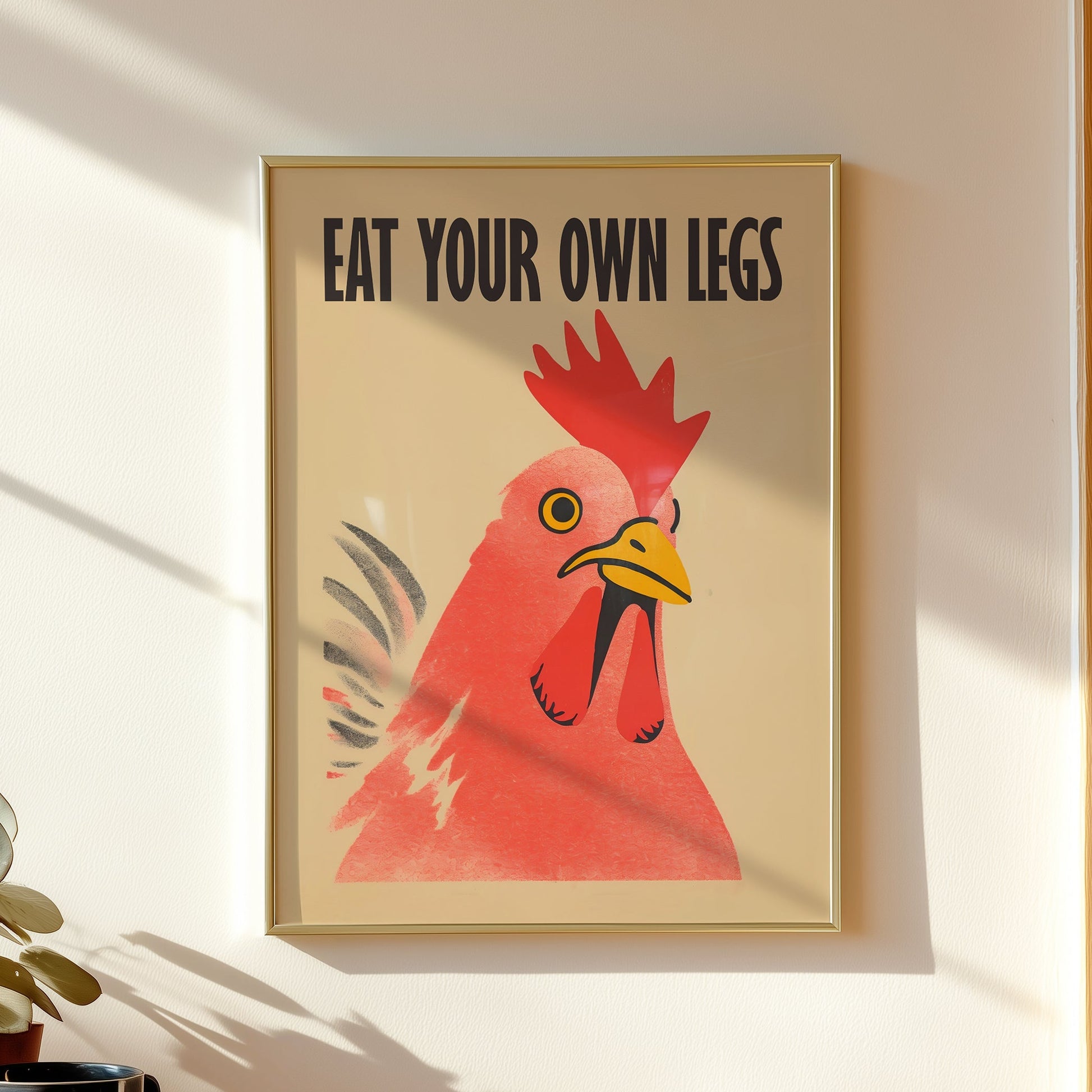 Bold retro illustration of a red chicken rooster with the provocative text "Eat Your Own Legs" in a vintage font, cream background, activist kitchen wall art.

