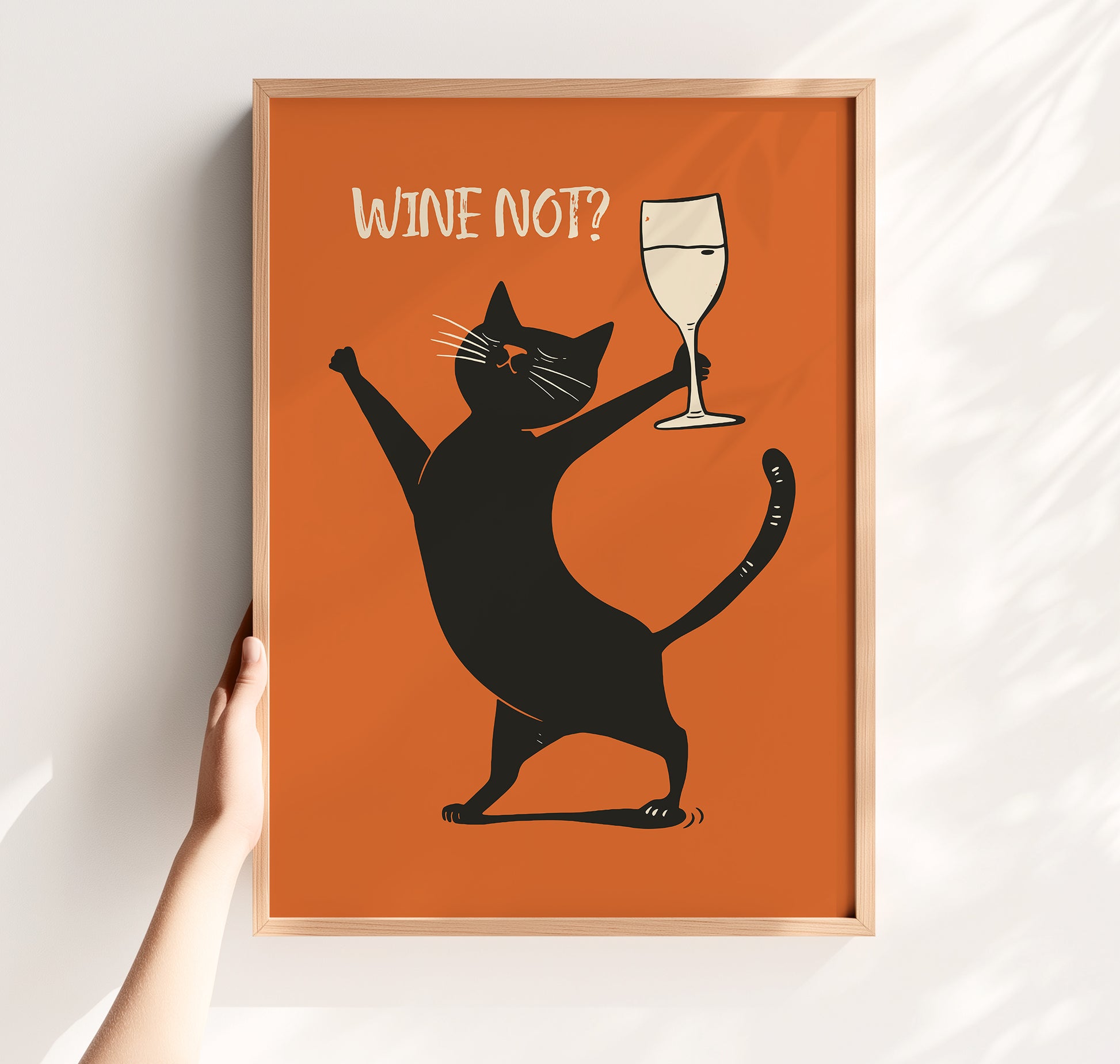 A whimsical mid-century modern illustration of a happy black cat holding up a glass of white wine with the text 'WINE NOT?' on a vibrant orange background.