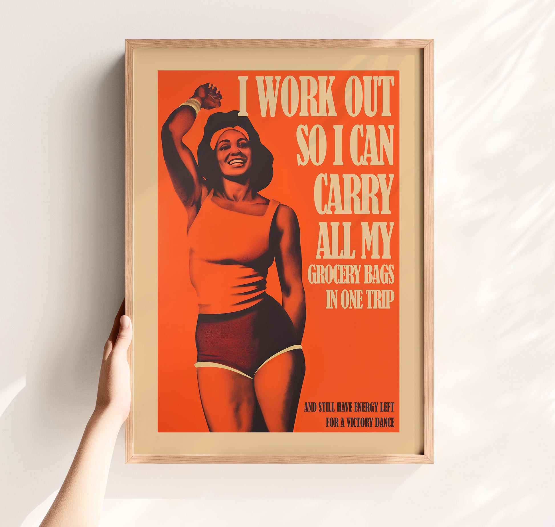Funny vintage-style gym poster featuring a smiling Black woman in athletic wear with the text "I work out so I can carry all my grocery bags in one trip and still have energy left for a victory dance."
