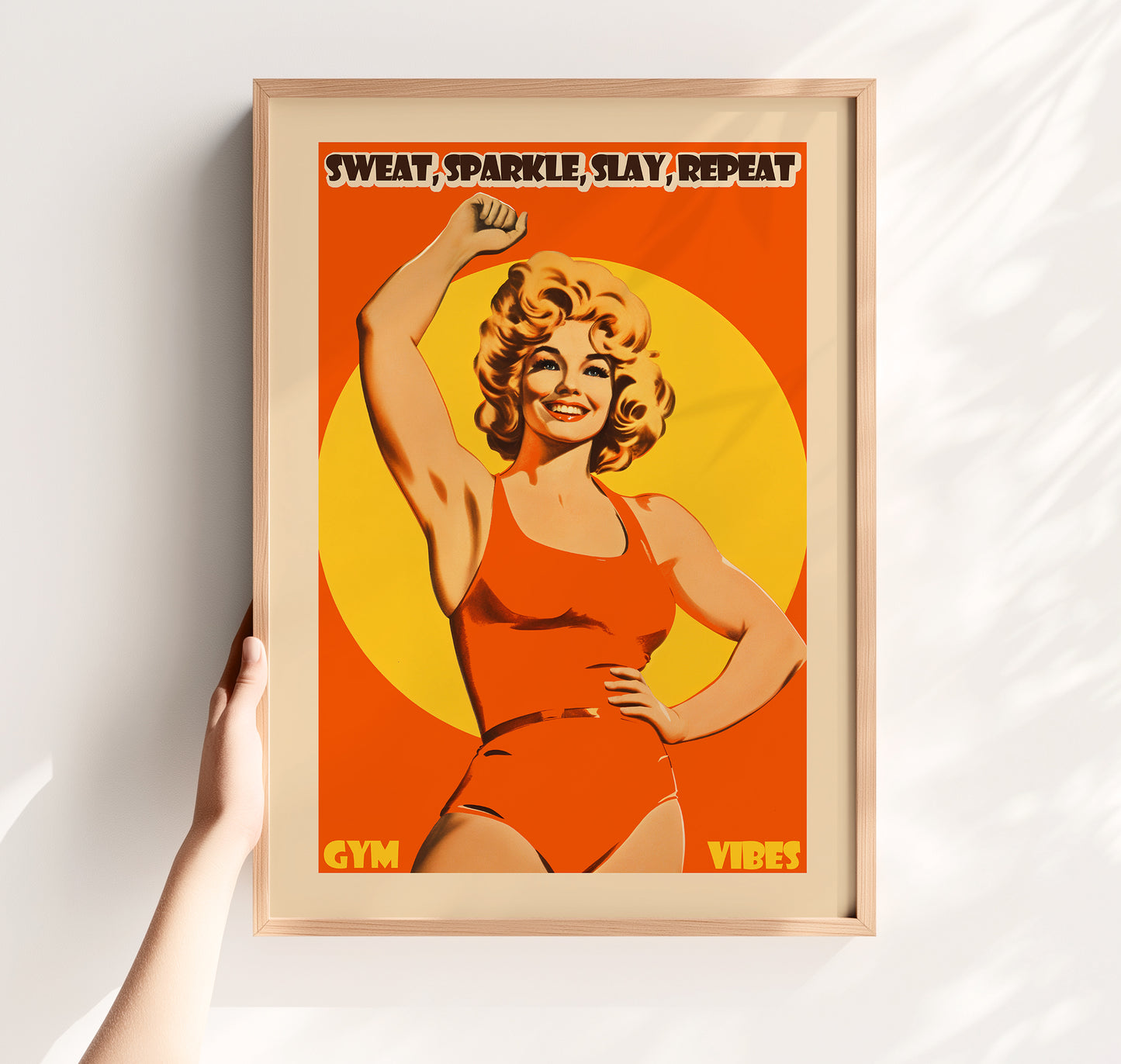 Retro 'Sweat Sparkle Slay Repeat' gym poster with a 70s-style blonde female fitness model in an orange bodysuit, vintage motivational wall art for a women's workout room.