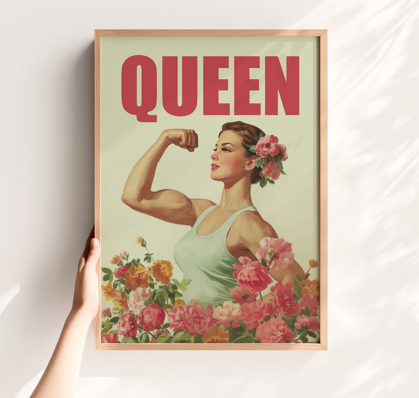 Vintage-style empowerment poster titled "QUEEN" featuring a muscular woman flexing her bicep amongst pink and yellow roses in a 1950s retro illustration style.