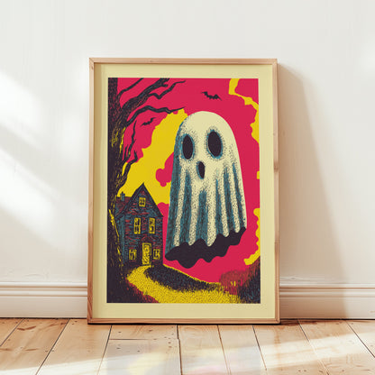 A framed art print featuring a spooky ghostly figure over a haunted house, leaning against a white wall on a light wood floor.