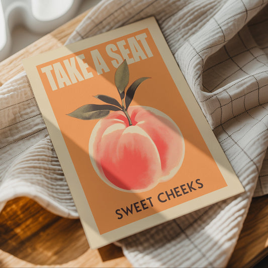 Take a Seat Sweet Cheeks bathroom quote print styled on a magazine and neutral fabric.