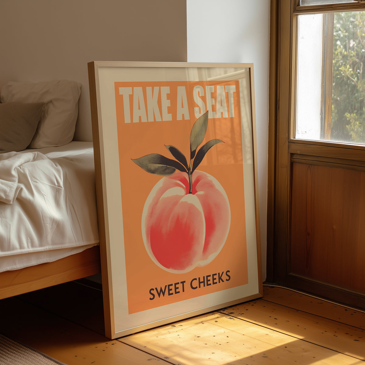 Peach bathroom quote print leaning beside wooden furniture.