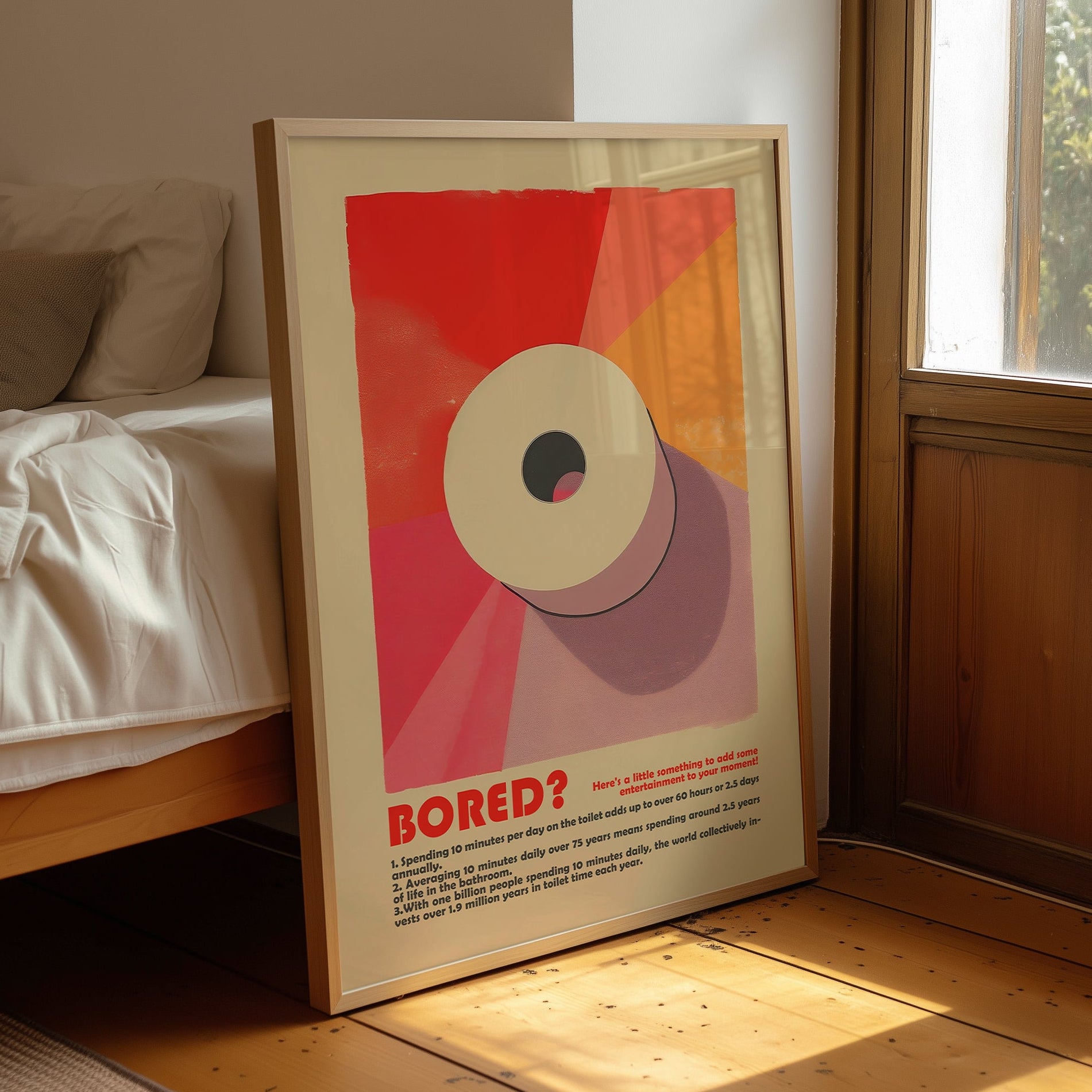 “Bored?” toilet facts poster displayed in a wooden frame beside a bed and window.
